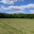 The Montgomery County Model Airplane Club air space is located in the open green space bordered by trees and mountain views.